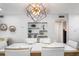 Contemporary dining room with a white table, modern chairs, geometric lighting, and decorative shelving at 5600 Beach Way Dr # 315, Sarasota, FL 34242