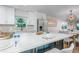 Well-lit eat-in kitchen with white cabinets and counters, a large island, and stylish modern decor at 5600 Beach Way Dr # 315, Sarasota, FL 34242