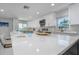 Bright eat-in kitchen with white countertops and cabinets, stainless appliances, and sleek modern decor at 5600 Beach Way Dr # 315, Sarasota, FL 34242
