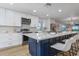 A well-appointed, modern eat-in kitchen with stainless appliances, a large island, and stylish decor at 5600 Beach Way Dr # 315, Sarasota, FL 34242