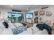 Bright living room featuring a white sectional sofa and sliding glass doors leading to a balcony at 5600 Beach Way Dr # 315, Sarasota, FL 34242