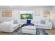 Comfortable living room featuring a large white sectional sofa and modern artwork at 5600 Beach Way Dr # 315, Sarasota, FL 34242