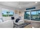 Cozy living room with a plush sectional, large windows, access to a balcony, and ocean views at 5600 Beach Way Dr # 315, Sarasota, FL 34242