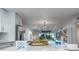 Open concept space with modern white kitchen, dining area, and a comfortable living room at 5600 Beach Way Dr # 315, Sarasota, FL 34242