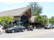 Exterior view of a beach restaurant featuring a tropical-style roof and street parking at 5600 Beach Way Dr # 315, Sarasota, FL 34242