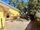 Exterior of home, side view, leading to a large, unfenced yard at 5615 Waneta Pl, Sarasota, FL 34231