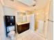 Well-lit bathroom with a vanity, mirror, and a separate shower area at 5615 Waneta Pl, Sarasota, FL 34231