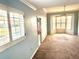 Corner bedroom with multiple windows providing great natural light and neutral carpet at 5615 Waneta Pl, Sarasota, FL 34231