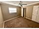 Bedroom featuring neutral walls, brown carpet, ceiling fan, a window with blinds, and a closet at 5615 Waneta Pl, Sarasota, FL 34231