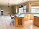 View of kitchen bar with wine rack and seating, flowing into an open living area at 5615 Waneta Pl, Sarasota, FL 34231