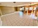 Spacious living room featuring tile floors and a kitchen with bar seating at 5615 Waneta Pl, Sarasota, FL 34231