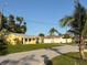 Street view showing the home's position, lawn, and nearby palm trees at 5615 Waneta Pl, Sarasota, FL 34231
