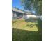 Spacious backyard with a patio, lawn, and privacy fence, perfect for outdoor enjoyment at 5848 Milton Ave, Sarasota, FL 34243
