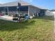 Lawn and patio featuring outdoor equipment and privacy fence at 5848 Milton Ave, Sarasota, FL 34243