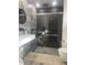 Modern bathroom featuring a glass-enclosed shower, sleek fixtures, and contemporary gray tiling at 5848 Milton Ave, Sarasota, FL 34243