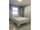 Bright bedroom with a comfortable bed, white marble floors, and a large window at 5848 Milton Ave, Sarasota, FL 34243