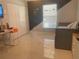Modern bedroom with stylish desk, closet and accent wall with white marble floors at 5848 Milton Ave, Sarasota, FL 34243