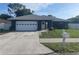 Charming single-story home with a well-manicured lawn, white garage door, and inviting front entrance at 5848 Milton Ave, Sarasota, FL 34243