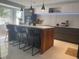 Modern kitchen with a large island, counter seating, and pendant lighting at 5848 Milton Ave, Sarasota, FL 34243