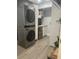 Modern laundry room with stacked washer/dryer and built-in sink and cabinets at 5848 Milton Ave, Sarasota, FL 34243