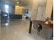 Open-concept living and dining area with marble floors, modern furniture, and plenty of natural light at 5848 Milton Ave, Sarasota, FL 34243