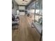 Inviting sunroom featuring wood floors, an outdoor kitchen, and comfortable seating at 5848 Milton Ave, Sarasota, FL 34243