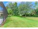 Lush backyard with green grass, trees, and landscape at 6423 Royal Tern Cir, Lakewood Ranch, FL 34202