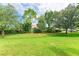 Expansive green backyard with mature trees and well-maintained landscaping at 6423 Royal Tern Cir, Lakewood Ranch, FL 34202