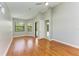 Well-lit bedroom with hardwood floors, dual windows, access to the bathroom, and neutral walls at 6423 Royal Tern Cir, Lakewood Ranch, FL 34202
