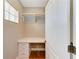Walk-in closet with built-in desk and shelving, offering organized storage solutions and a functional workspace at 6423 Royal Tern Cir, Lakewood Ranch, FL 34202