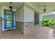 Inviting front porch with beautiful stone columns and trim with a blue front door at 6423 Royal Tern Cir, Lakewood Ranch, FL 34202