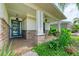 Charming front porch with stone columns and trim, beautiful landscaping and a blue front door at 6423 Royal Tern Cir, Lakewood Ranch, FL 34202