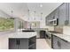 Modern kitchen featuring stainless steel appliances, a center island, tiled backsplash, and stylish pendant lighting at 6423 Royal Tern Cir, Lakewood Ranch, FL 34202