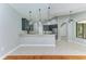 Open kitchen features an island, stainless appliances, granite counters, and modern pendant lighting at 6423 Royal Tern Cir, Lakewood Ranch, FL 34202