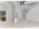 Bright living room features beige tiling, light-grey walls, an arched doorway and a modern chandelier light fixture at 6423 Royal Tern Cir, Lakewood Ranch, FL 34202