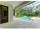 Screened-in pool area featuring a waterfall feature and view of lush landscaping, offering a relaxing outdoor space at 6423 Royal Tern Cir, Lakewood Ranch, FL 34202