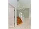 View of a wood staircase with white railings inside a home with neutral color tiling and high ceilings with a ceiling fan at 6423 Royal Tern Cir, Lakewood Ranch, FL 34202