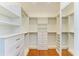 Spacious walk-in closet with custom shelving, drawers, and ample storage at 6423 Royal Tern Cir, Lakewood Ranch, FL 34202