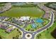 An aerial view of a community with a large lake, clubhouse, pool, tennis and basketball courts at 6507 Clairborne Ln, Bradenton, FL 34211