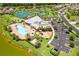 Aerial view of the clubhouse featuring a pool, tennis courts, playground, parking and bocce ball court at 6507 Clairborne Ln, Bradenton, FL 34211