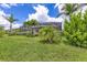 This property features lush green grass and tropical landscaping, perfect for enjoying the outdoors at 6507 Clairborne Ln, Bradenton, FL 34211