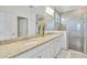 Bathroom features double vanity, granite countertops, and glass-enclosed shower with decorative tile at 6507 Clairborne Ln, Bradenton, FL 34211