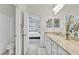 Bathroom features a vanity with granite countertops and a decorative vase with views into the bedroom at 6507 Clairborne Ln, Bradenton, FL 34211