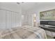 Neutral bedroom features double closets, ceiling fan, and desk area with ensuite bathroom access at 6507 Clairborne Ln, Bradenton, FL 34211