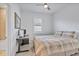 Bright bedroom with neutral decor, ceiling fan, and a convenient desk area near the window at 6507 Clairborne Ln, Bradenton, FL 34211