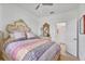 Bright bedroom with ceiling fan and ornate bedframe with matching dresser and ensuite bathroom access at 6507 Clairborne Ln, Bradenton, FL 34211