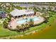A resort-style pool and lounge area with palm trees, lounge chairs and lush landscaping next to the lake at 6507 Clairborne Ln, Bradenton, FL 34211