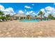 Large community pool surrounded by lounge chairs and lush landscaping at 6507 Clairborne Ln, Bradenton, FL 34211