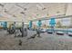 A bright fitness center with cardio equipment and weights, offering views of the pool and outdoor scenery at 6507 Clairborne Ln, Bradenton, FL 34211