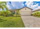 A charming single Gathering home featuring a well-manicured lawn, brick paver driveway, and two-car garage at 6507 Clairborne Ln, Bradenton, FL 34211